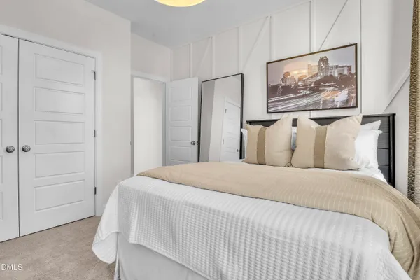 a bedroom with a bed and a painting on the wall