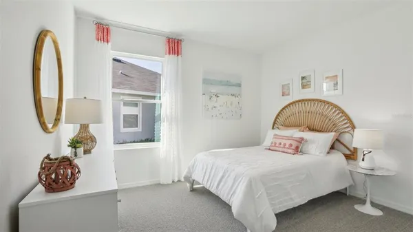 a bedroom with a bed and a painting on the wall