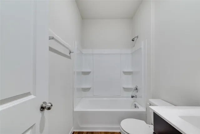 a bathroom with a toilet and a bath tub