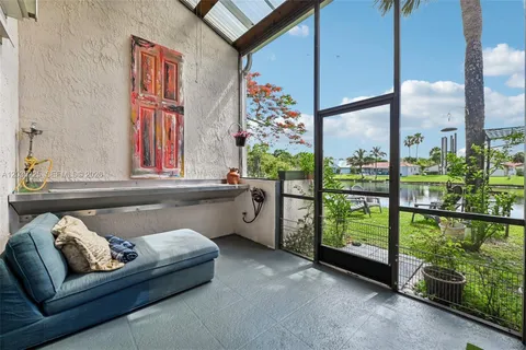 a living room with furniture and a floor to ceiling window
