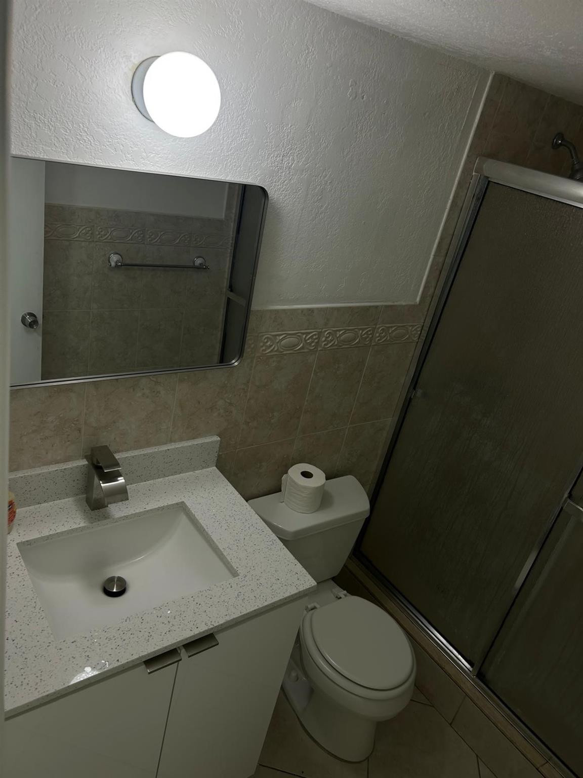 9441 Southwest 4th Street, Unit 202 Miami, FL 33174 - Photo 12 of 21 a bathroom with a sink a toilet and mirror
