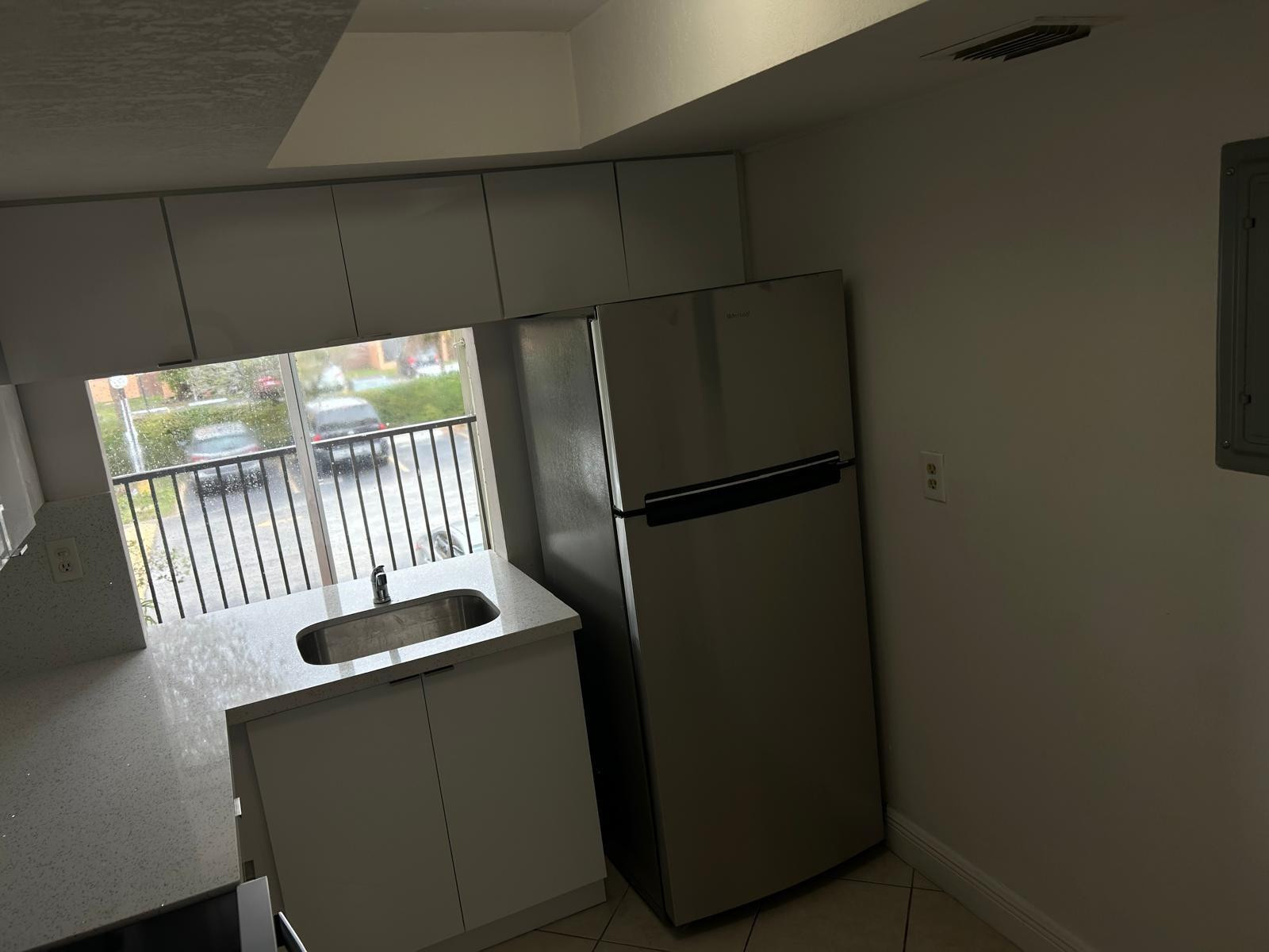 9441 Southwest 4th Street, Unit 202 Miami, FL 33174 - Photo 19 of 21 a kitchen with a refrigerator and a window