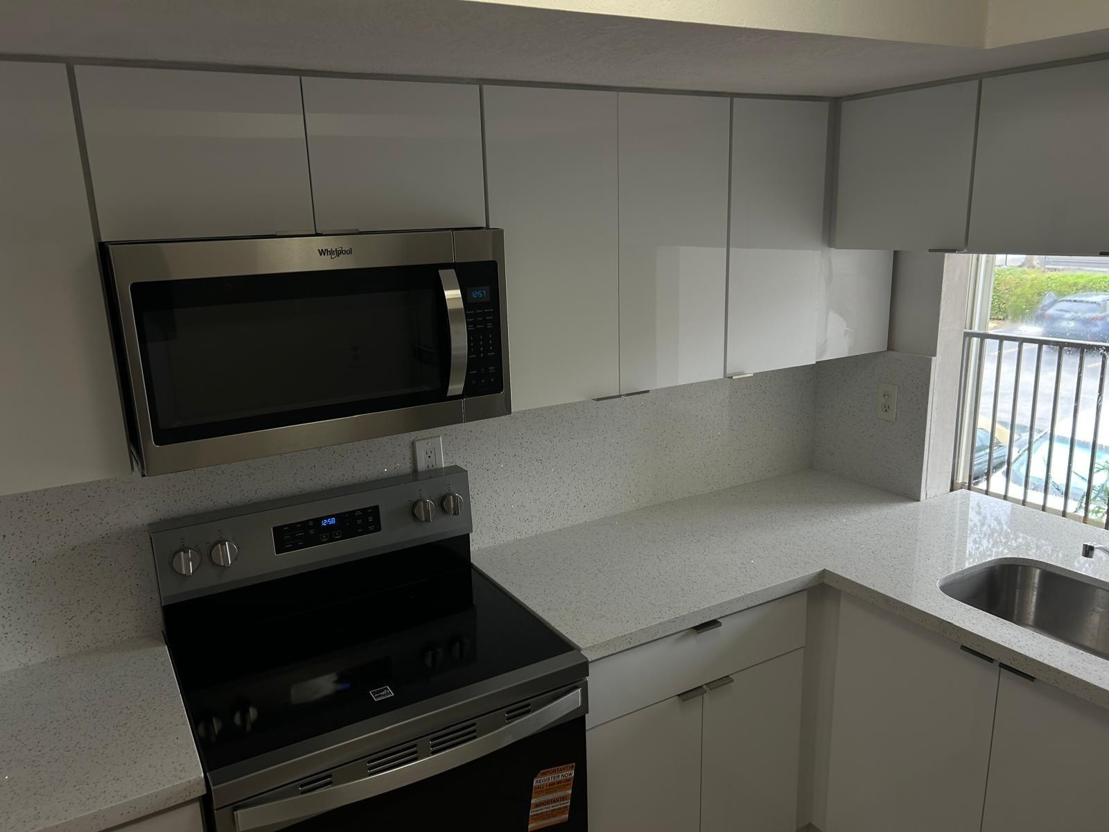 9441 Southwest 4th Street, Unit 202 Miami, FL 33174 - Photo 20 of 21 a kitchen with a microwave and a sink