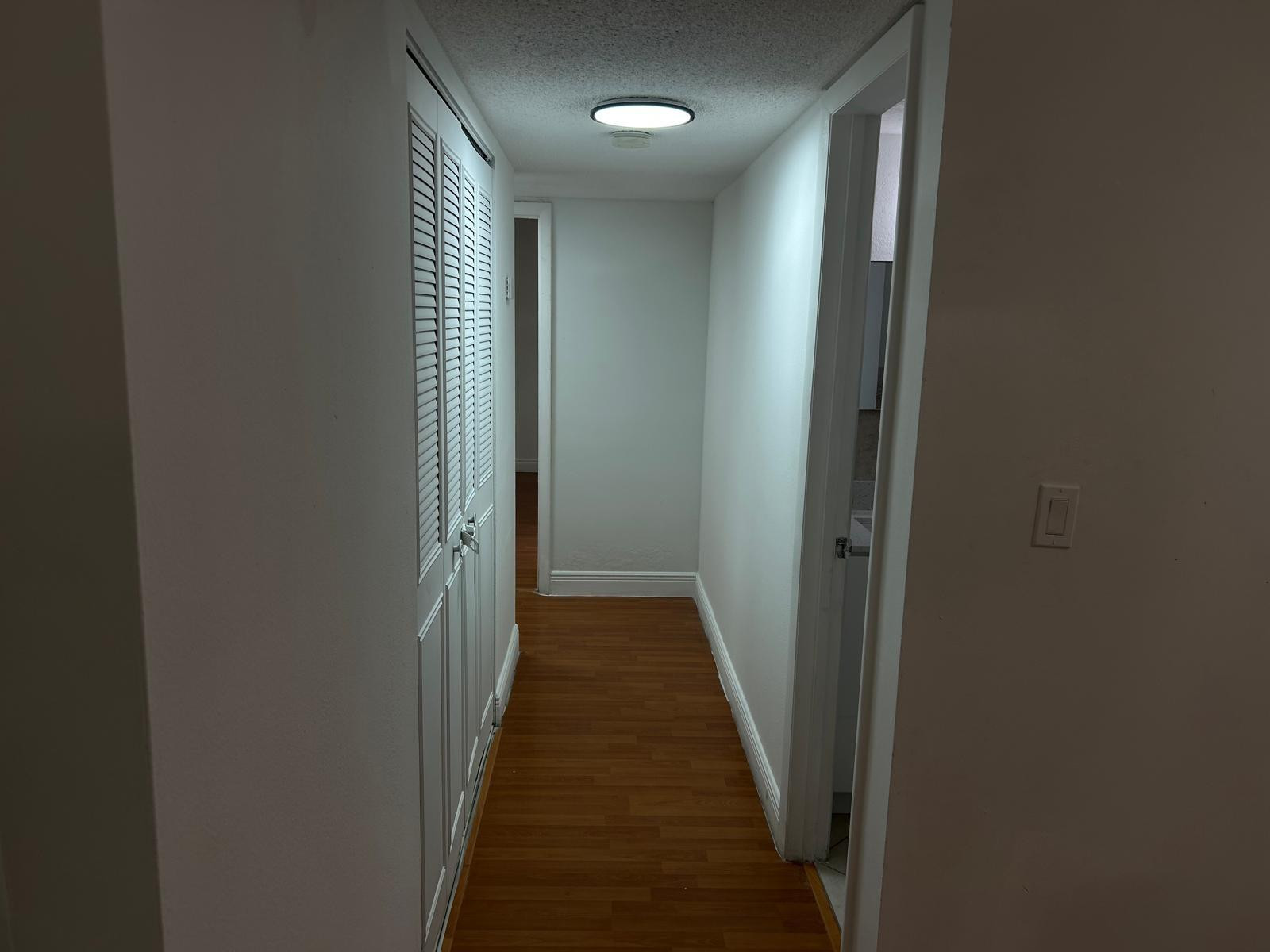 9441 Southwest 4th Street, Unit 202 Miami, FL 33174 - Photo 7 of 21 a view of a hallway with wooden floor