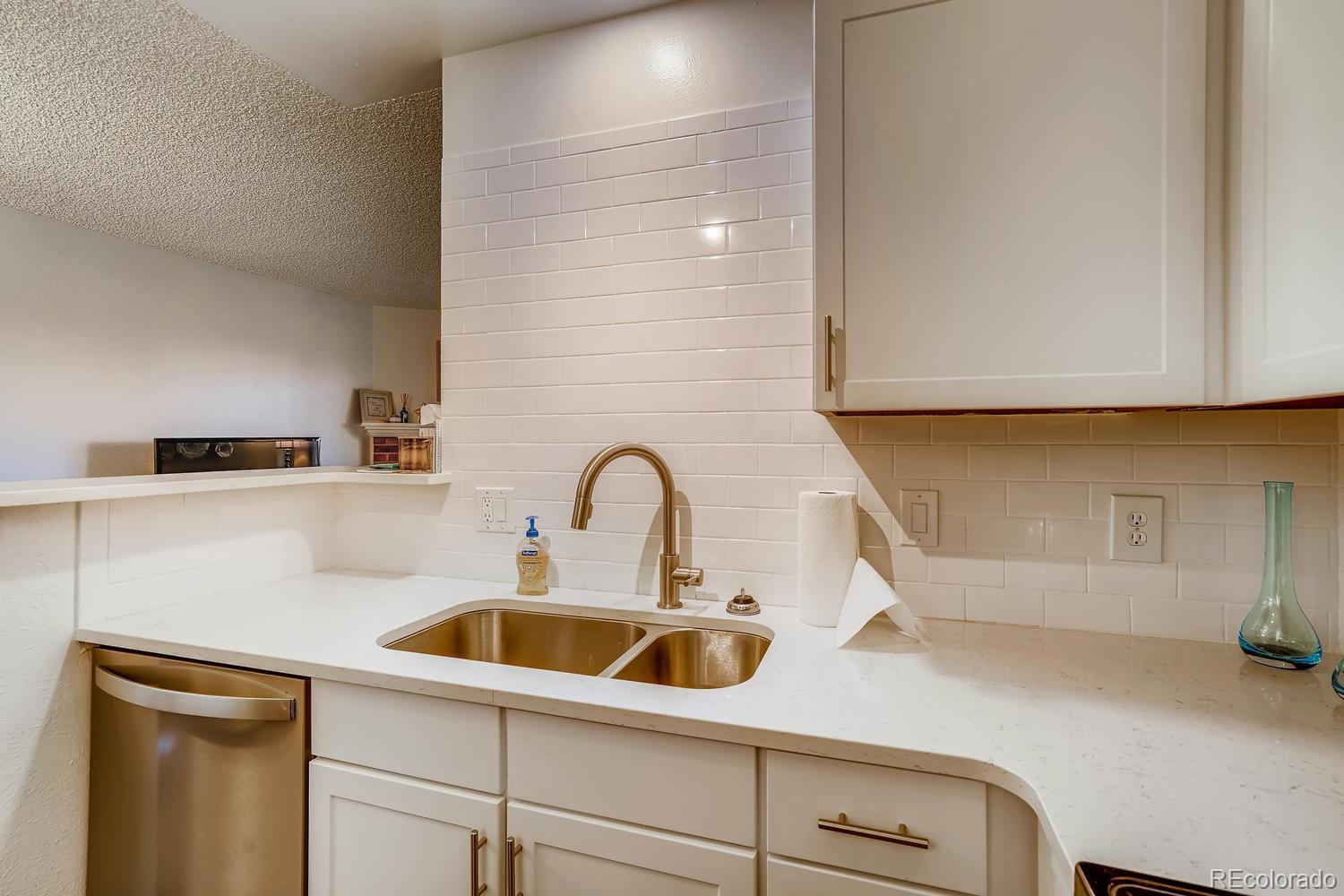 7881 Allison Way, Unit 202 Arvada, CO 80005 - Photo 12 of 26 a kitchen with a sink and cabinets