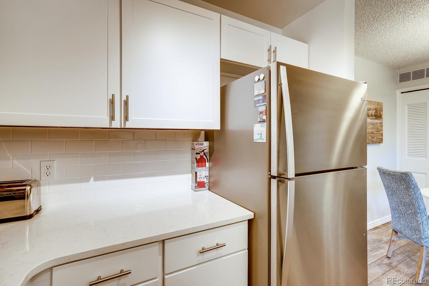 7881 Allison Way, Unit 202 Arvada, CO 80005 - Photo 13 of 26 a white refrigerator freezer sitting in a kitchen