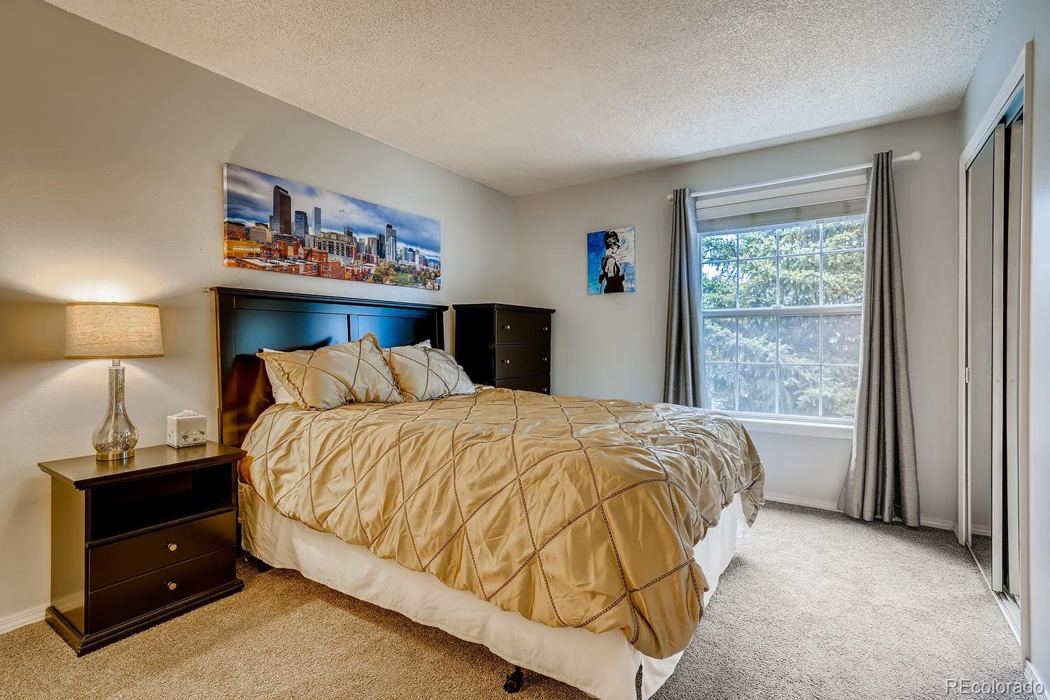 7881 Allison Way, Unit 202 Arvada, CO 80005 - Photo 14 of 26 a bedroom with a bed and a window