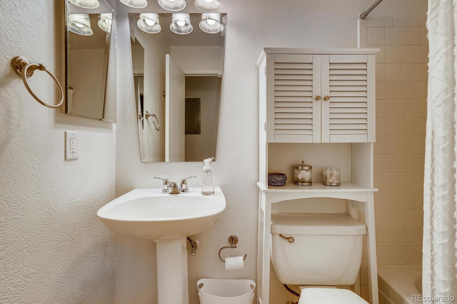 7881 Allison Way, Unit 202 Arvada, CO 80005 - Photo 22 of 26 a bathroom with a toilet a sink and a mirror