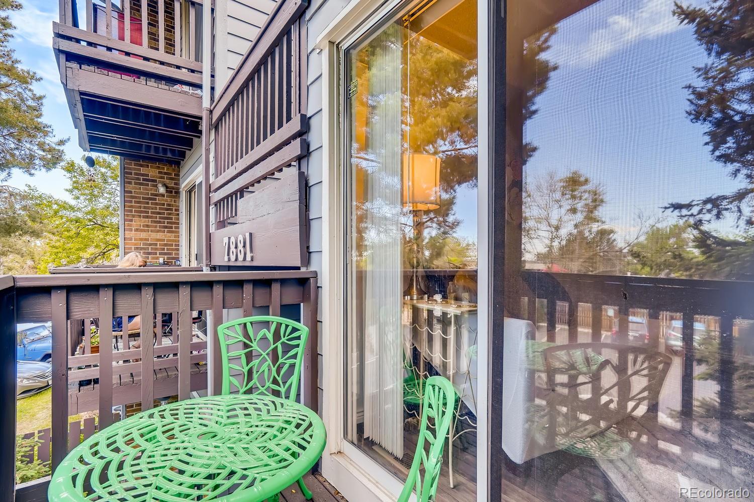 7881 Allison Way, Unit 202 Arvada, CO 80005 - Photo 25 of 26 a view of a porch with a table and chairs