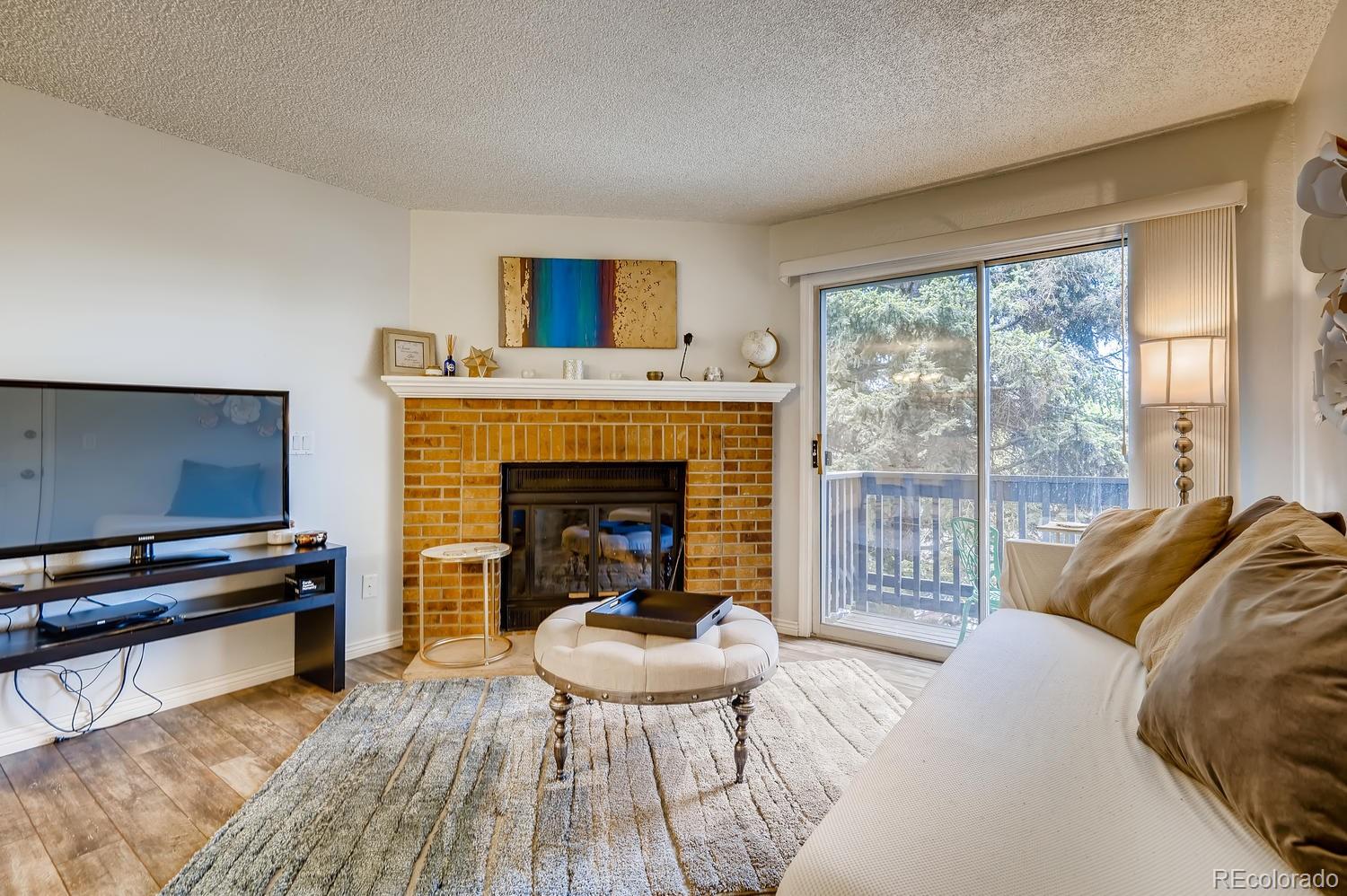 7881 Allison Way, Unit 202 Arvada, CO 80005 - Photo 4 of 26 a living room with furniture and a fireplace