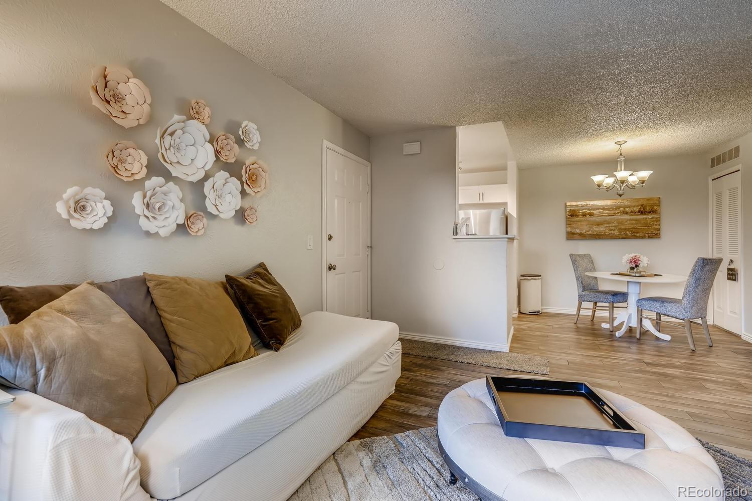 7881 Allison Way, Unit 202 Arvada, CO 80005 - Photo 6 of 26 a living room with furniture and wooden floor