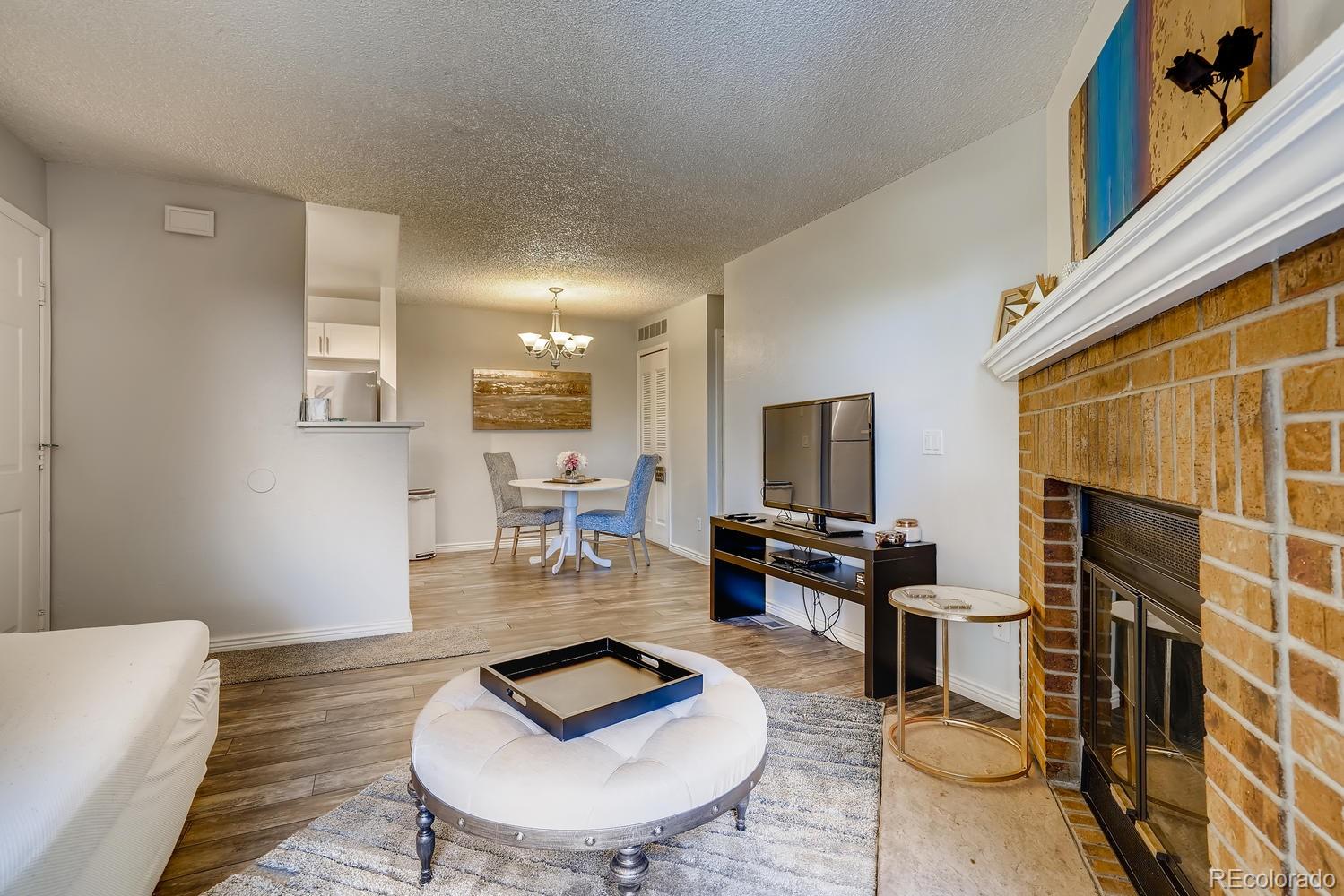 7881 Allison Way, Unit 202 Arvada, CO 80005 - Photo 7 of 26 a living room with furniture and a wooden floor