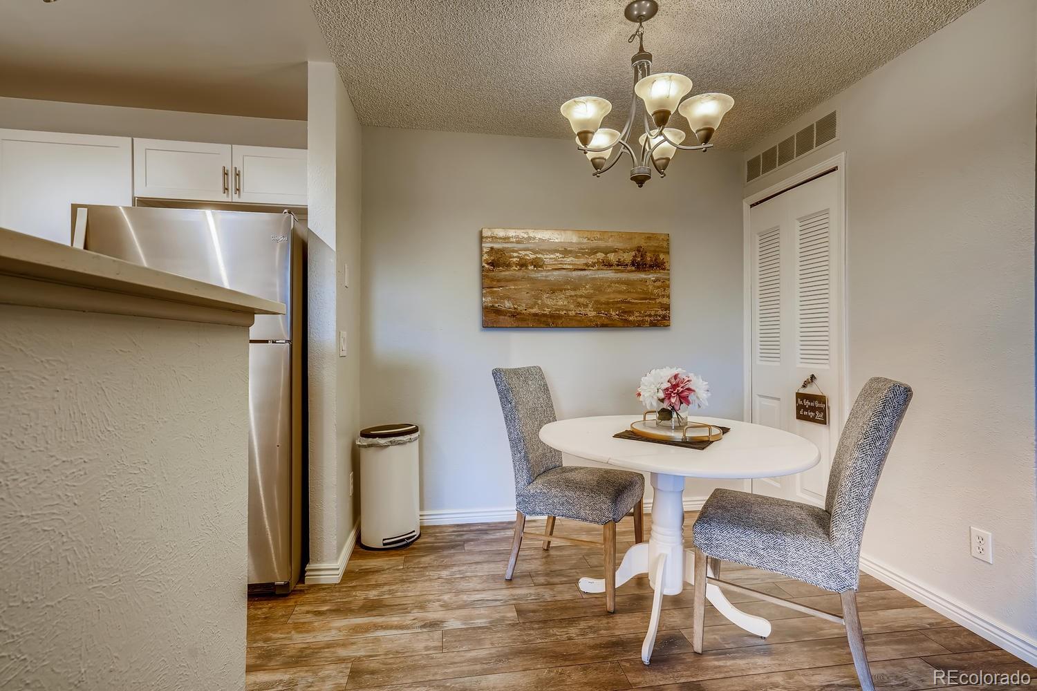 7881 Allison Way, Unit 202 Arvada, CO 80005 - Photo 8 of 26 a view of a dining room with furniture and chandelier
