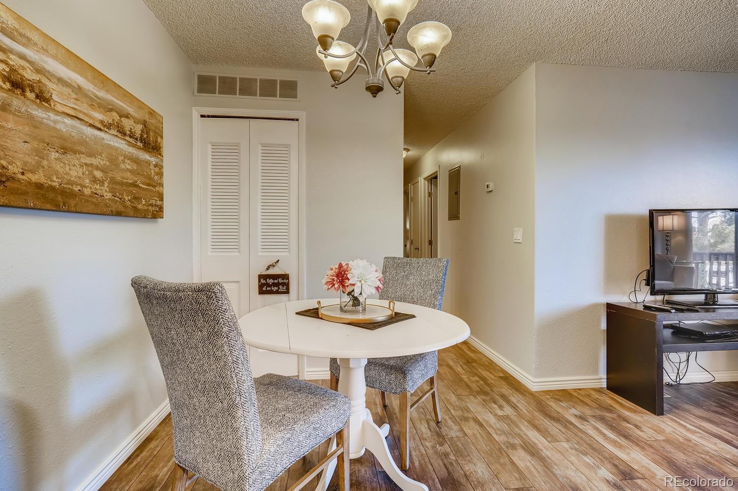 7881 Allison Way, Unit 202 Arvada, CO 80005 - Photo 9 of 26 a dining room with furniture and wooden floor