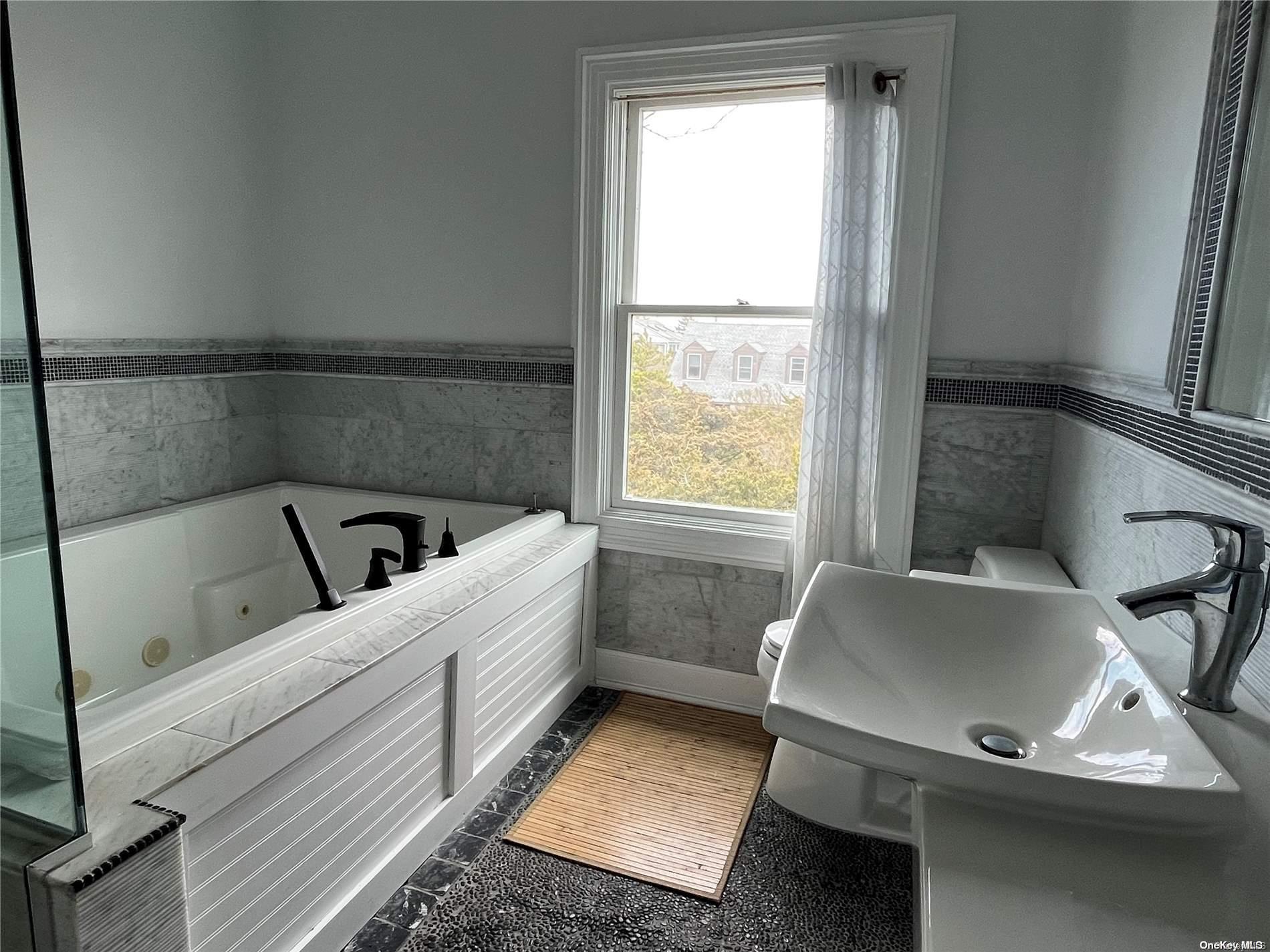 860 Ocean View Walk Ocean Beach, NY 11770 - Photo 11 of 14 a room with a couch and a window