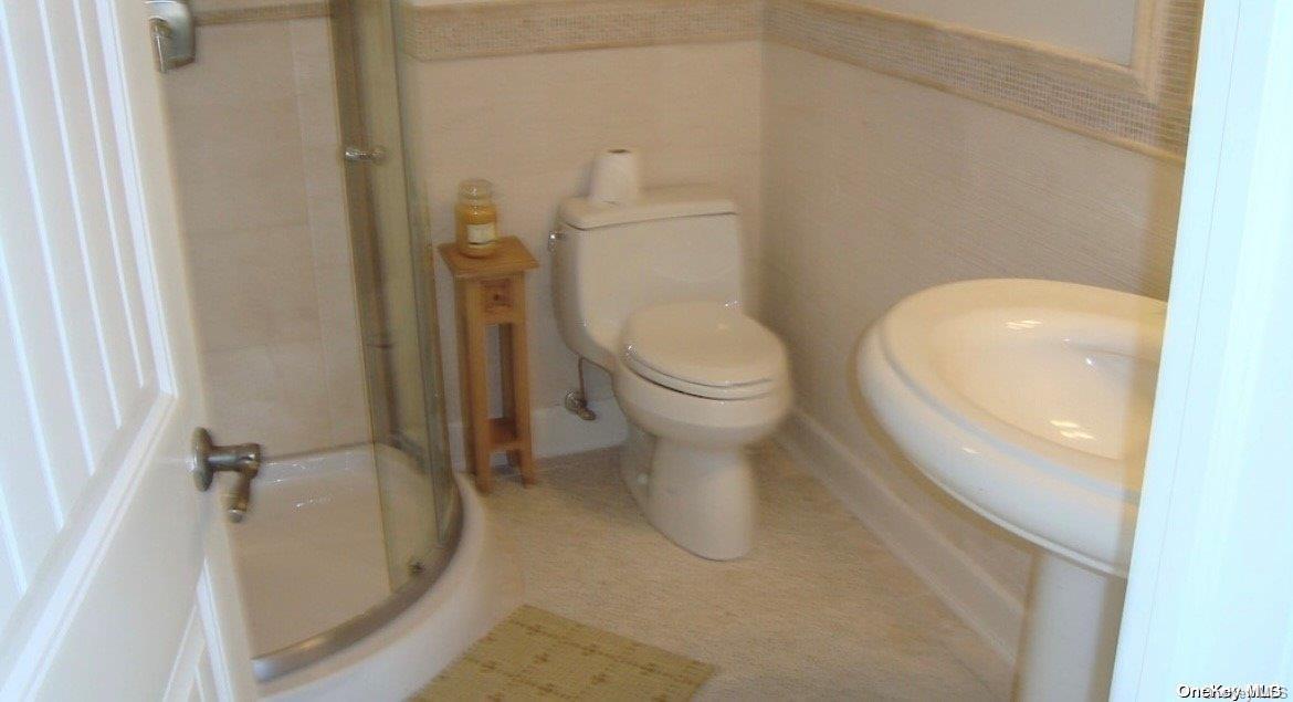 860 Ocean View Walk Ocean Beach, NY 11770 - Photo 13 of 14 a white toilet sitting next to a shower