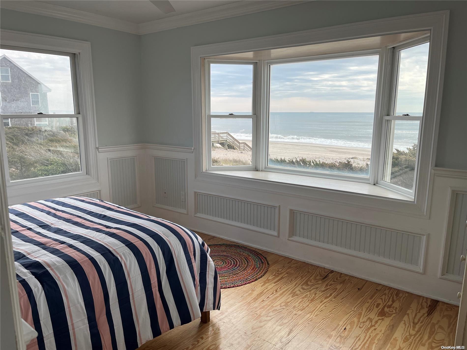 860 Ocean View Walk Ocean Beach, NY 11770 - Photo 6 of 14 a bedroom with a bed and a window