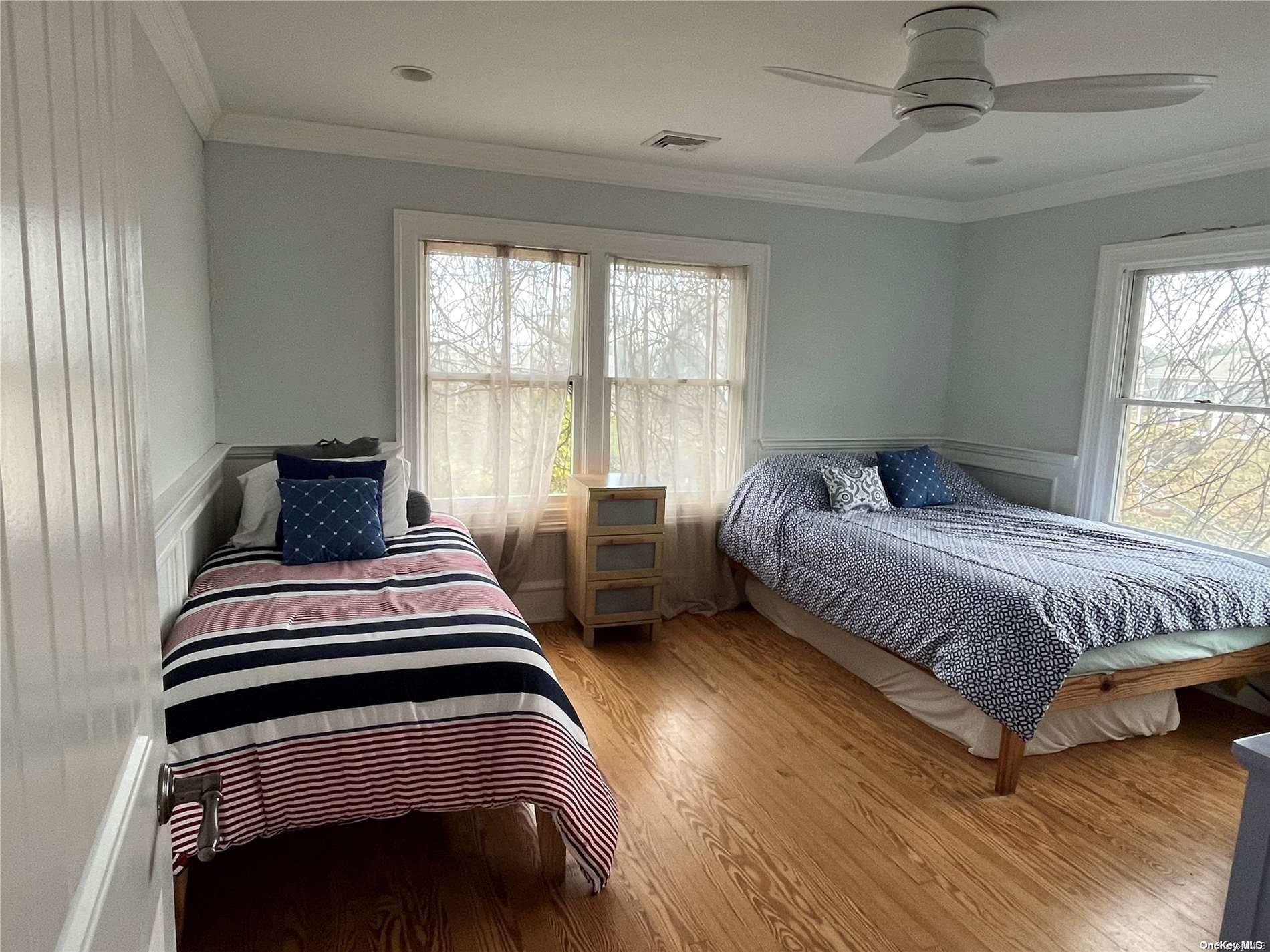 860 Ocean View Walk Ocean Beach, NY 11770 - Photo 7 of 14 a bedroom with a bed and wooden floor