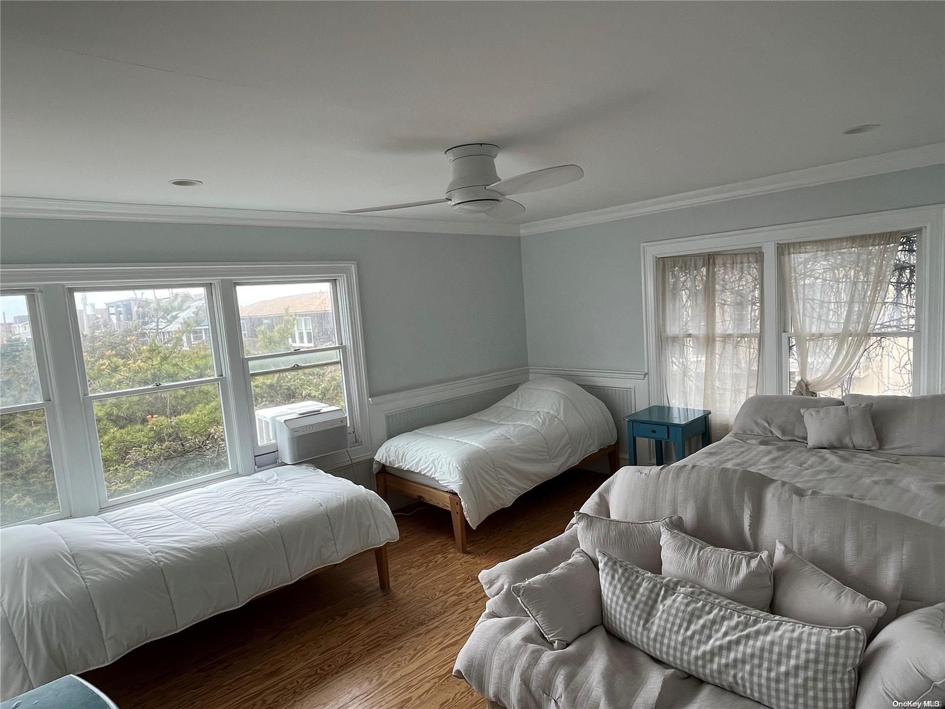 860 Ocean View Walk Ocean Beach, NY 11770 - Photo 9 of 14 a bedroom with two beds and a large window