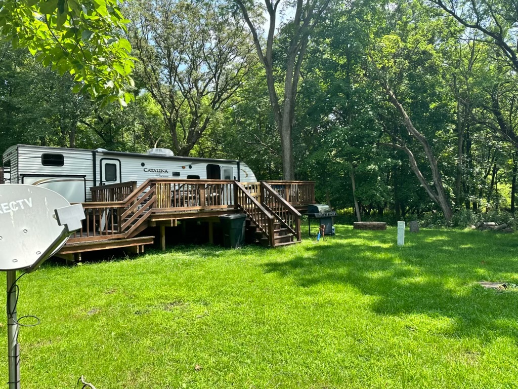 a view of a chair and table on the green field