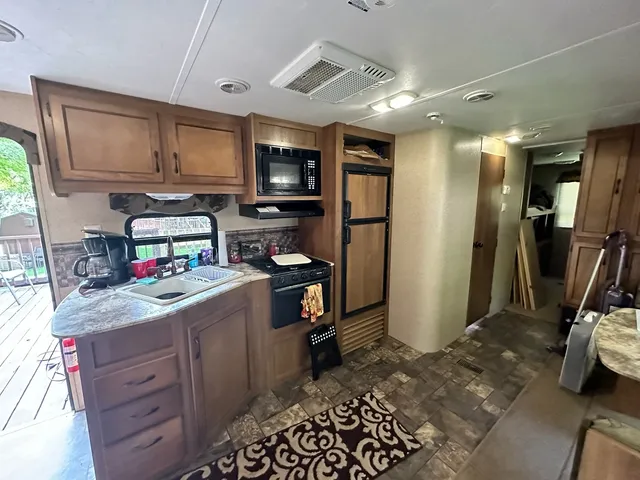 a kitchen with a refrigerator and a sink