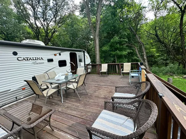 a view of a patio with table and chairs and couches