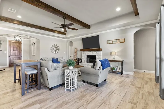 a living room with furniture a fireplace and a flat screen tv
