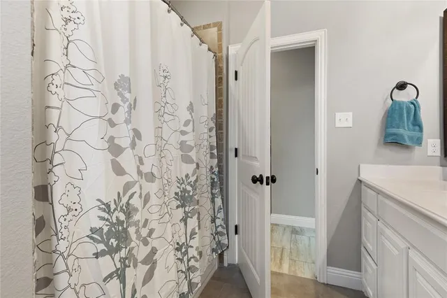 a bathroom with a shower and a sink