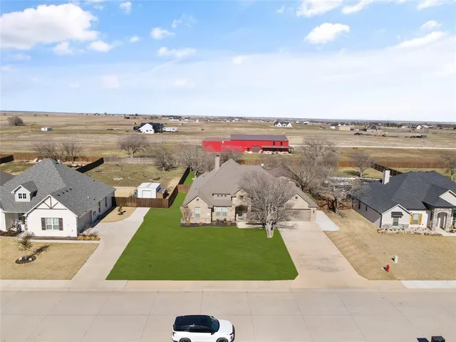 an aerial view of a house with outdoor space swimming pool and ocean view
