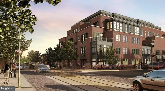 a view of a building and car parked on the side of road