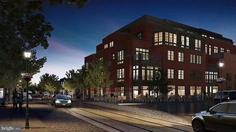 a front view of a building with parked cars