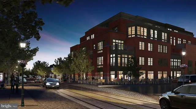 a front view of a building with parked cars