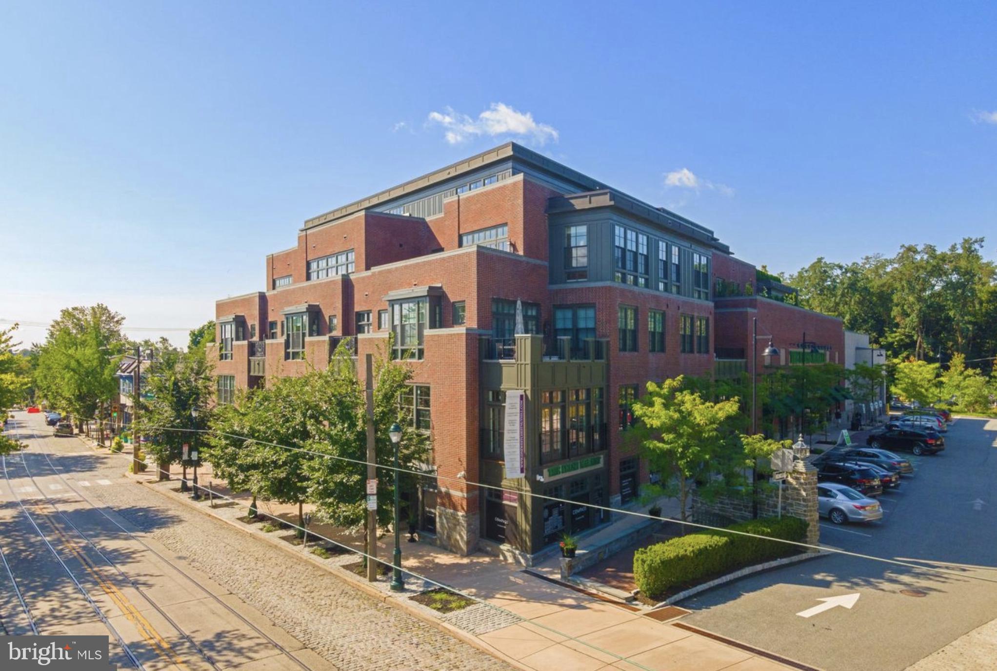 1 West Hartwell Lane, Unit 3C Philadelphia, PA 19118 - Photo 4 of 6 a front view of a house with a yard