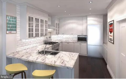 a kitchen with stainless steel appliances granite countertop a sink and a refrigerator