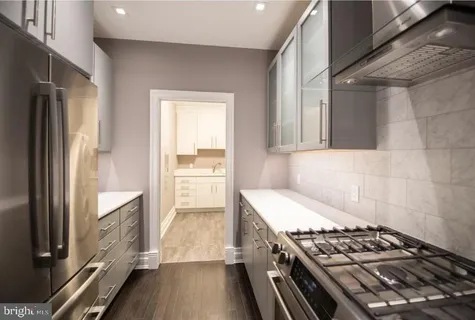 a kitchen with a stove and a refrigerator