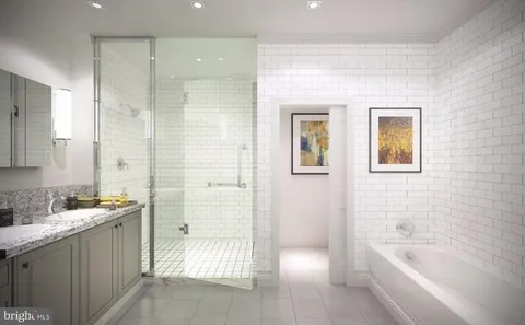 a bathroom with a bathtub sink and mirror