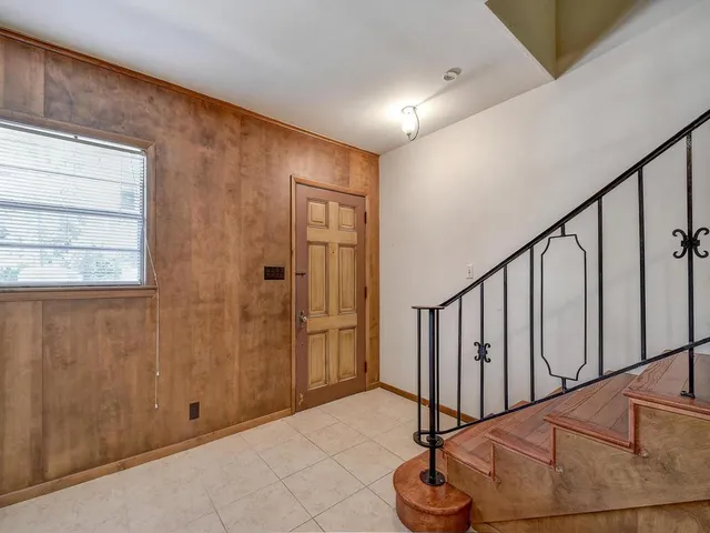 a view of entryway with stairs and a chandelier