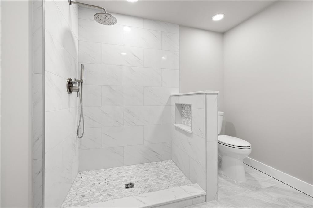 6470 Samoa Way Flowery Branch, GA 30542 - Photo 52 of 61 a bathroom with a shower a toilet and sink