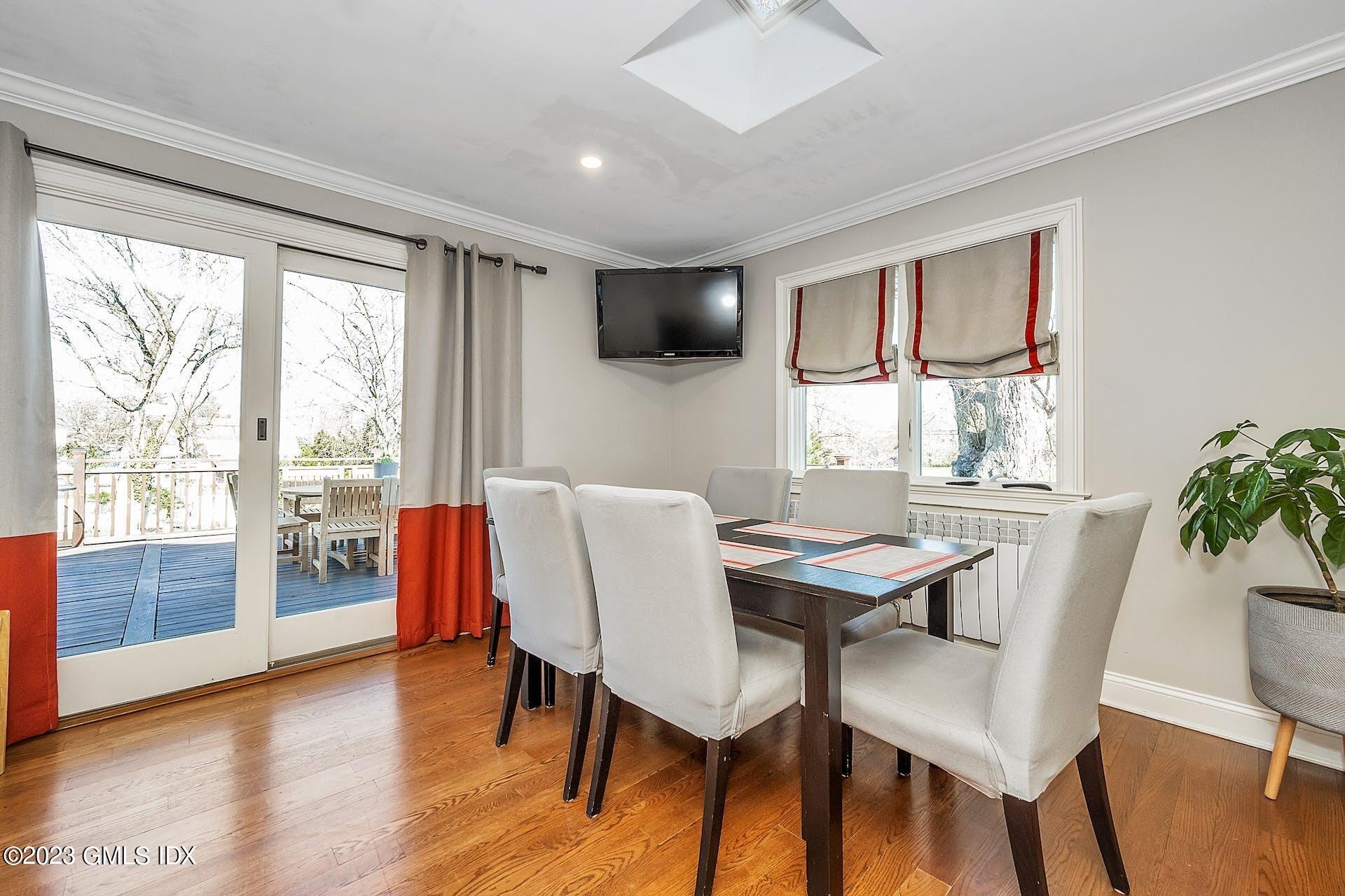 58 Upland Road Stamford, CT 06906 - Photo 11 of 32 a view of a dining room with furniture and wooden floor