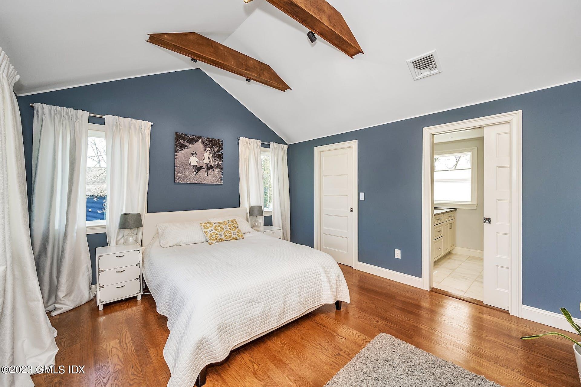 58 Upland Road Stamford, CT 06906 - Photo 17 of 32 a bedroom with a bed and a painting on the wall