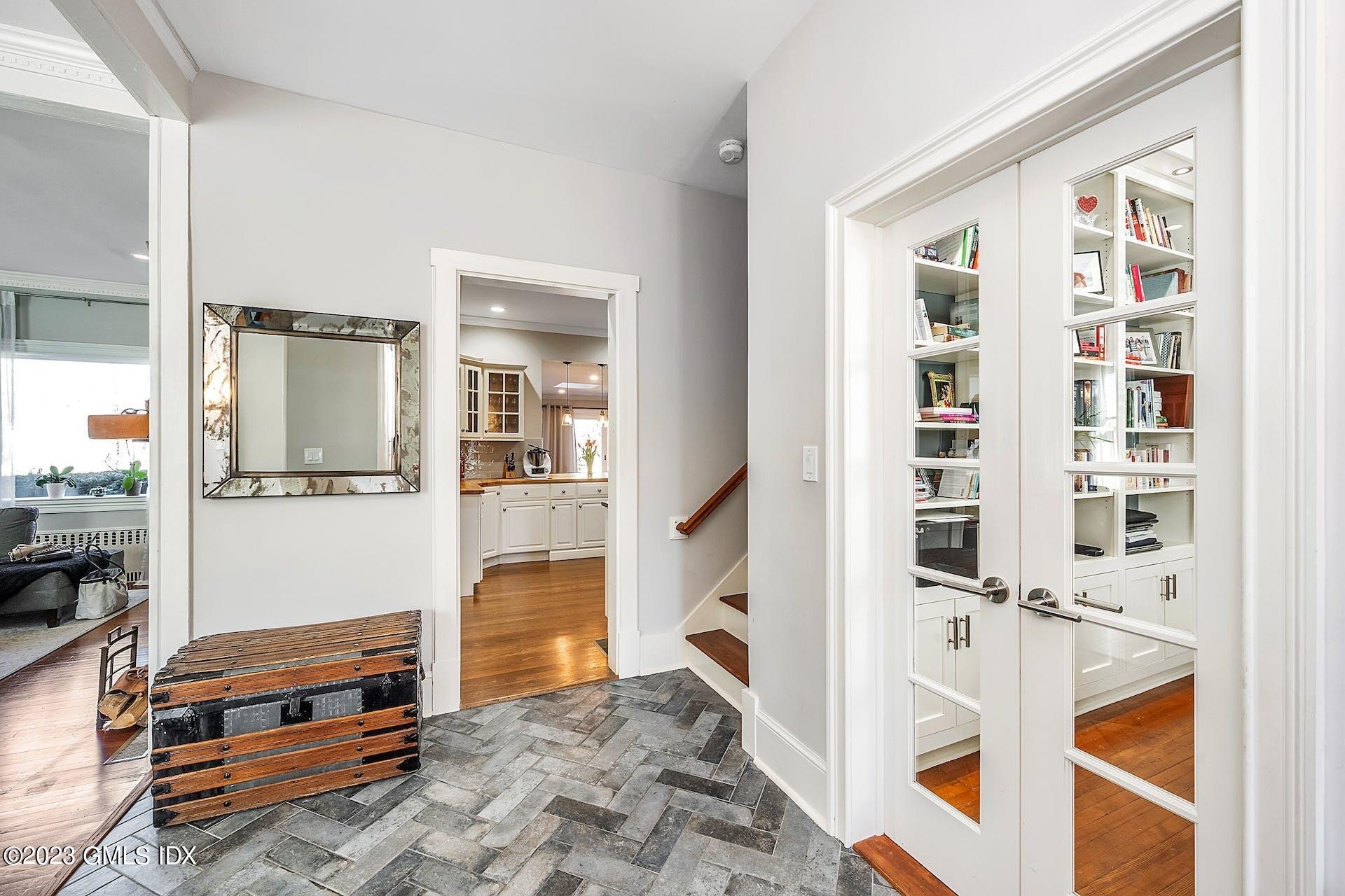58 Upland Road Stamford, CT 06906 - Photo 2 of 32 a living room with furniture and a book shelf