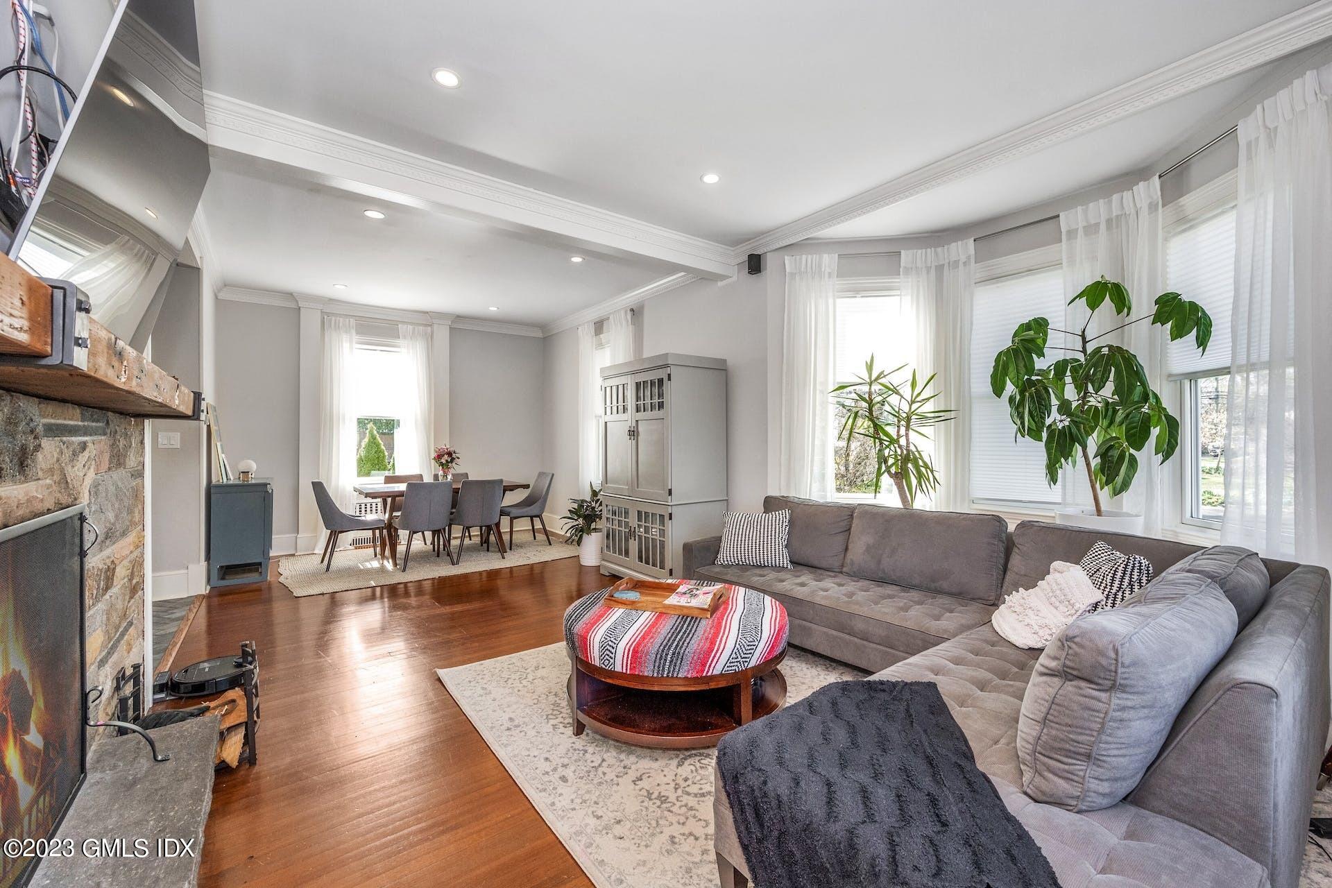 58 Upland Road Stamford, CT 06906 - Photo 4 of 32 a living room with fireplace furniture and a large window