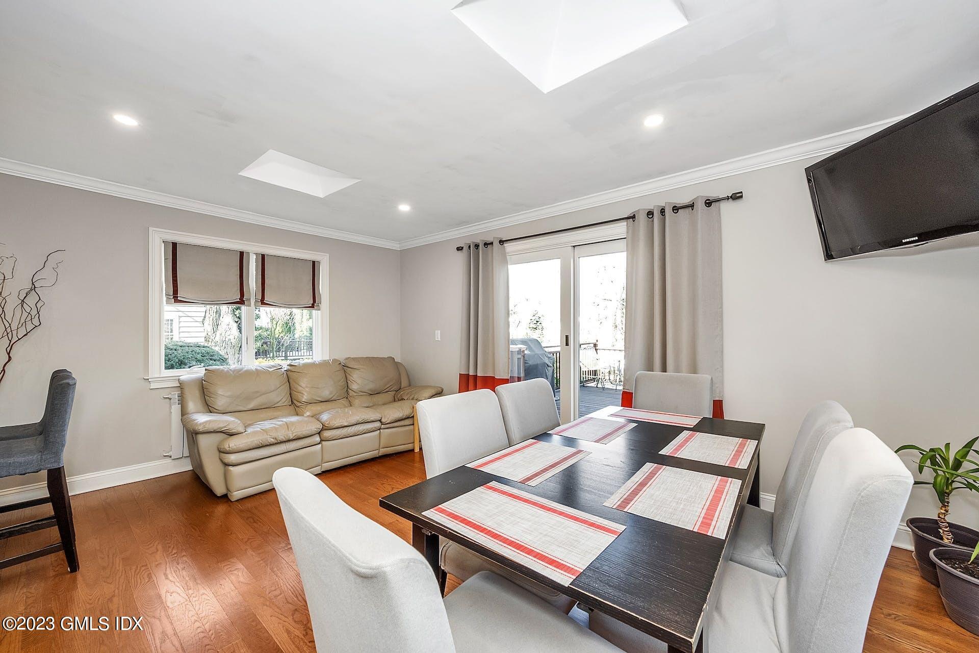 58 Upland Road Stamford, CT 06906 - Photo 10 of 32 a living room with furniture flat screen tv and a large window