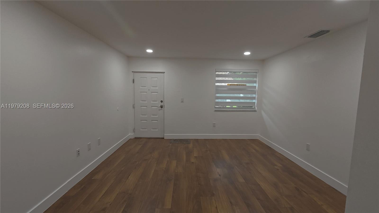 7121 Southwest 129th Avenue, Unit 8 Miami, FL 33183 - Photo 4 of 13 a view of an empty room with a window