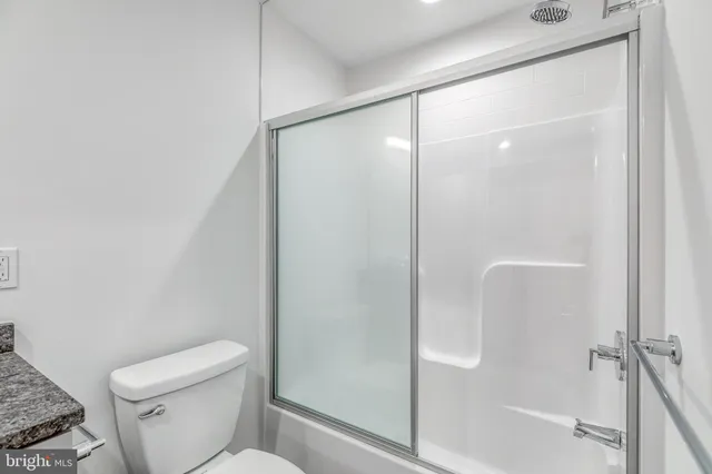 a bathroom with a shower a toilet and a shower