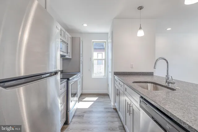 a kitchen with a refrigerator and countertop