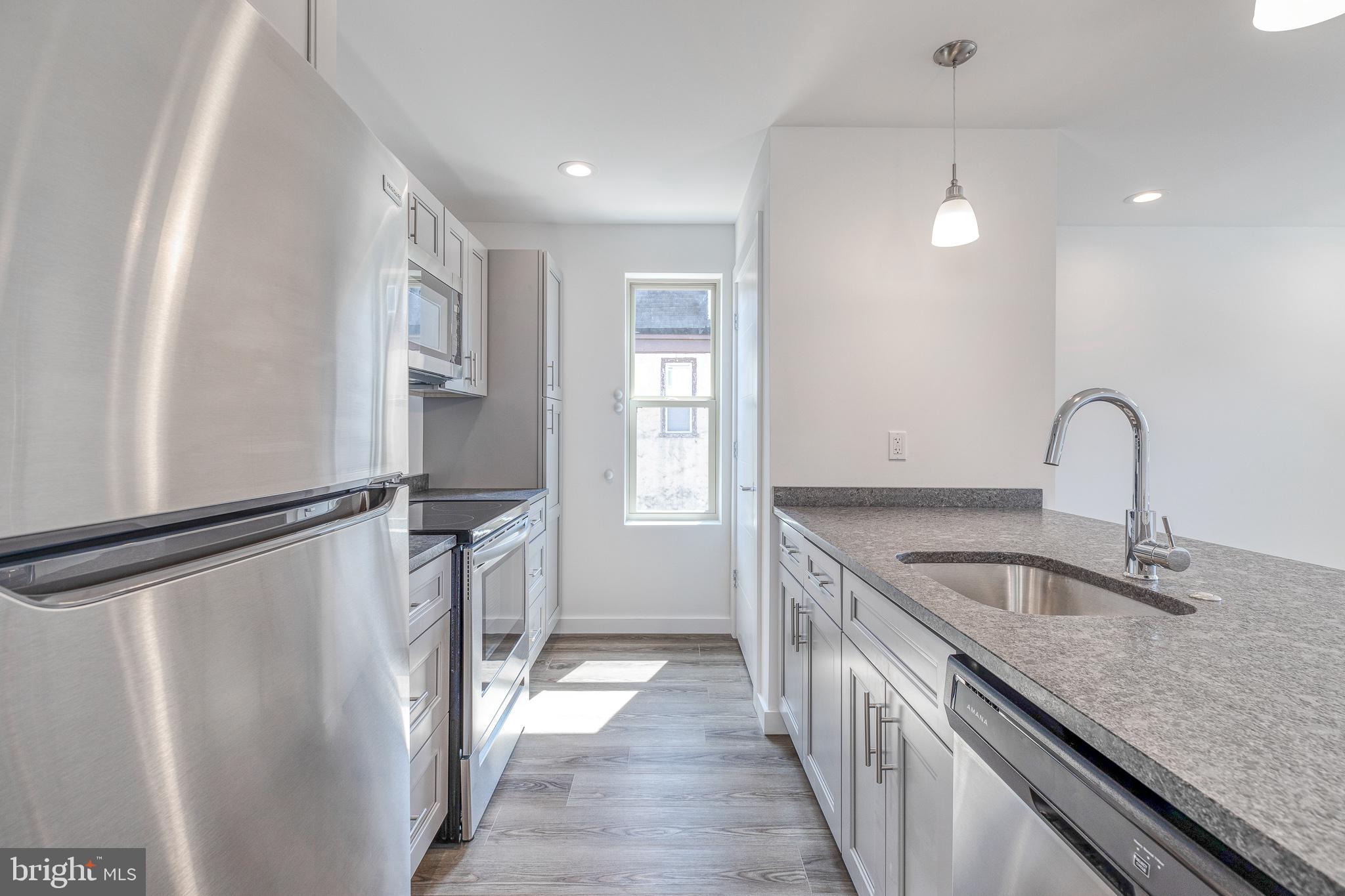 751 North 43rd Street, Unit 302 Philadelphia, PA 19104 - Photo 2 of 17 a kitchen with a refrigerator and countertop