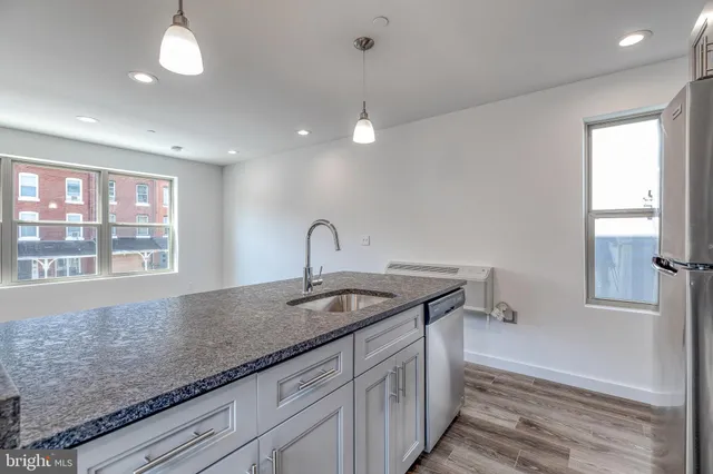 a kitchen with granite countertop a sink and a window