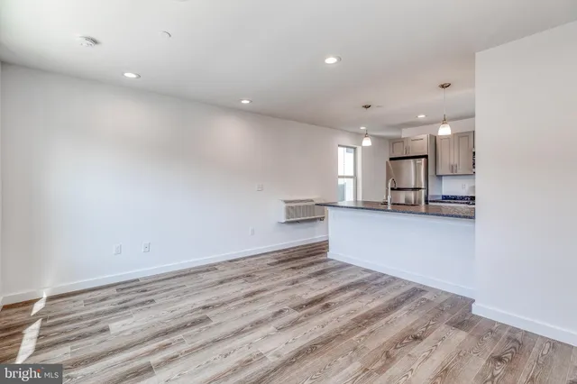 a view of kitchen and kitchen with a refrigerator