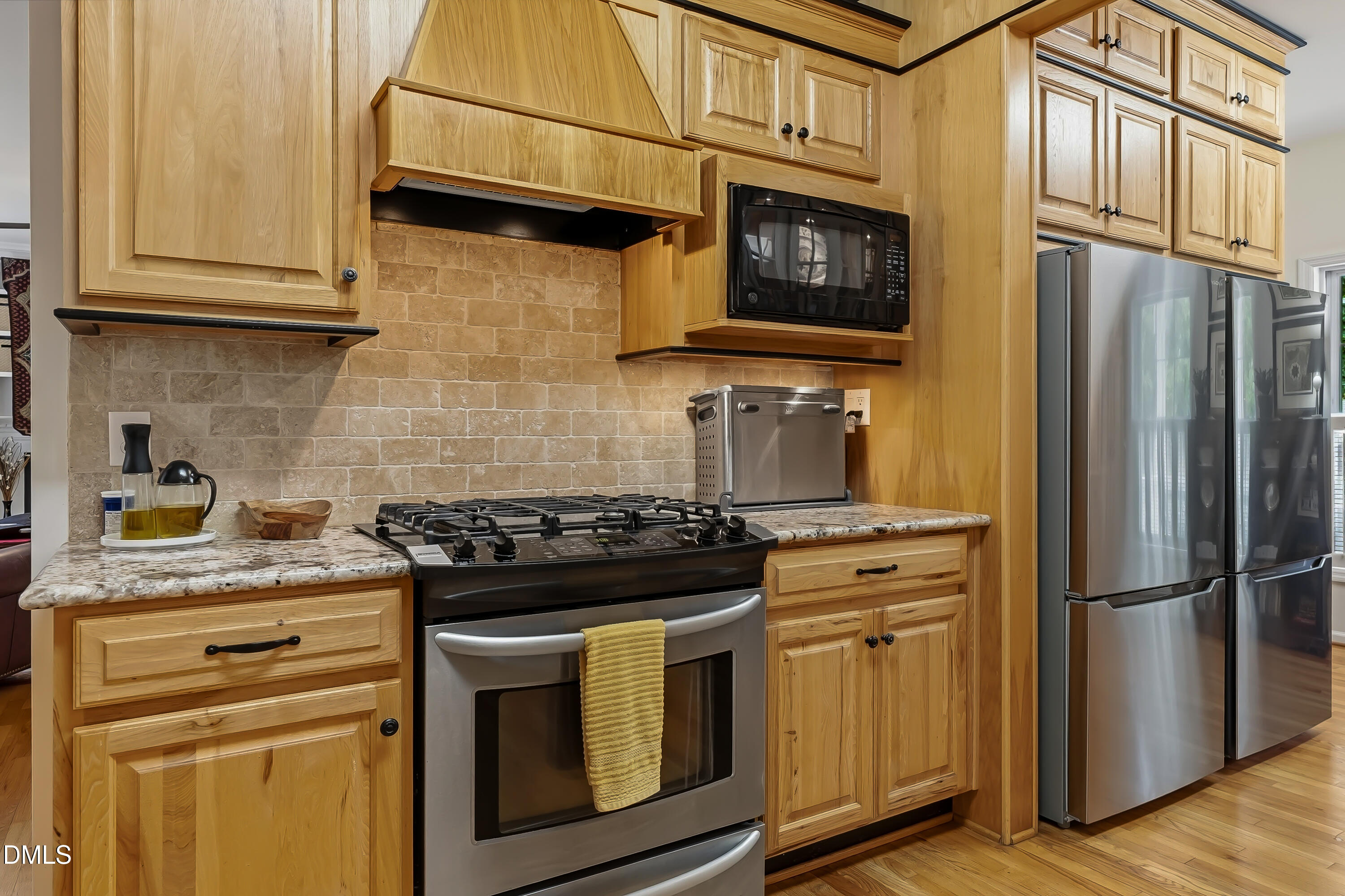 1214 Halcyon Place Rougemont, NC 27572 - Photo 23 of 69 a kitchen with stainless steel appliances granite countertop a stove microwave and refrigerator